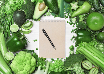 Wall Mural - Diet Plan. Closeup Of Green Vegetables And Notebook