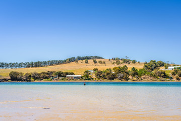 Cremorne Beach, South-Arm Peninsula, Tasmania, Australia: Relaxing quiet fishing day at a sandy beach river ocean coastline perfect sunny summer weather and blue water green mountains in background