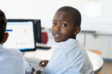 Wall Mural - African boy using computer at school