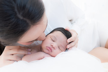 Wall Mural - happy mother with baby in bed