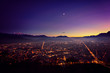 Grenoble after sunset surrouned by mountains