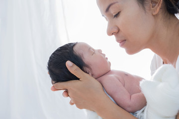 Wall Mural - happy mother with baby in bed