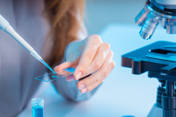 Poster - female technician take sample on microscope slide