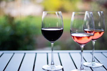 Wall Mural - Three Wine Glasses on Wooden Table