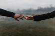 © Connect Images - Cropped view of young couple holding hands, fingers touching