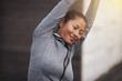 © Flamingo Images - Young Asian woman in sportswear stretching outside before exerci