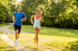 © BGStock72 - Young couple running in the park on a sunny day