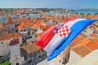 Flag and view on Trogir from Cathedral of Saint Lawrence, Croatia.