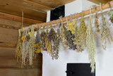 Different types of herbs dried on a rope inside house