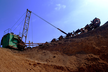 old bucket excavator of transverse dripping conducts the development of a quarry and extraction of clay