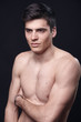 © HD92 - one young handsome man, model shirtless, simple studio upper body shot, black background.