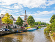 Windmill and bridge over canal in historic old town of Dokkum, Friesland, Netherlands