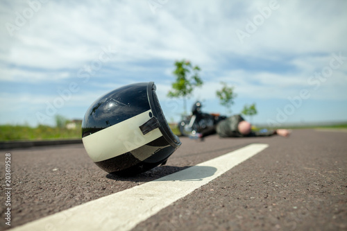 Fotografie, Obraz biker helmet lies on street near a motorcycle accident