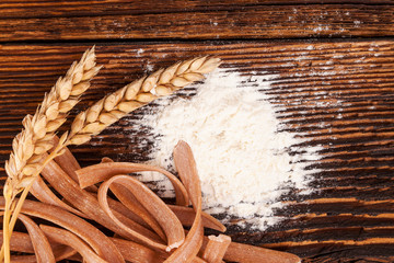 Wall Mural - Flour and wheat with spaghetti pasta.