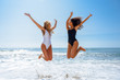 © javiindy - Two funny girls in swimsuit jumping on a tropical beach