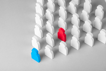 Wall Mural - Concept leader of the business team indicates the direction of the movement towards the goal. Crowd of white men goes for the leader of the blue color and  bad conflicting employee of  red color