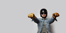 Young Biker In A Blue Denim Jacket Pretending To Ride A Motorcycle Isolated On White Background. Horizontal. Wide