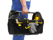 Mature plumber with tool bag on white background