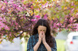 © Budimir Jevtic - Woman sneezing because of spring pollen allergy