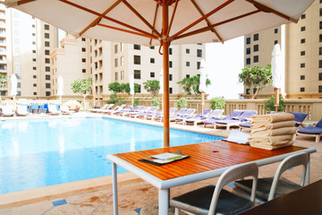Aufkleber - Stack of clean towel on wooden table near pool for service customer