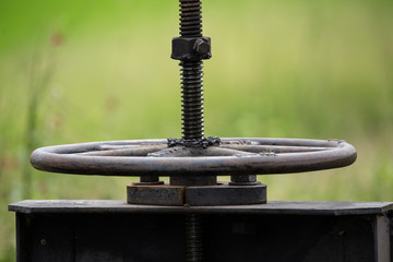 Iron wheel that opens a floodgate to  the water in the rice paddies of Thailand.