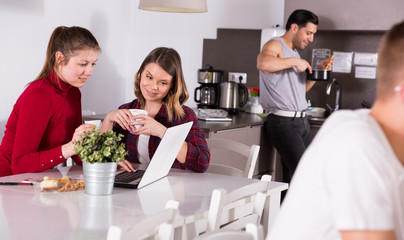 Poster - Two girls discussing in kitchen of hostel