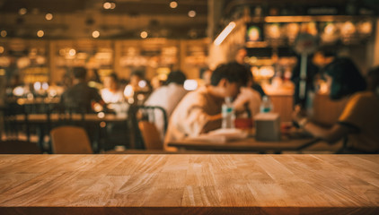 Wall Mural - Wood table top with blur of people in coffee shop or (cafe,restaurant )background
