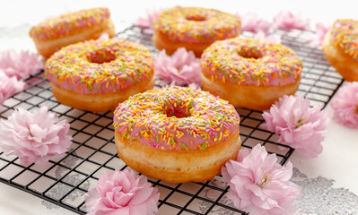 Wall Mural - Sweet pink fresh Donut decorated with japanese Flowering Cherry Tree flower