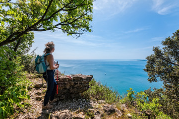 mature hiker looking the sea. travel and active lifestyle concept.