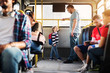 © dusanpetkovic1 - Young tall father and his little son are standing at the rear end of the bus and looking at each other.