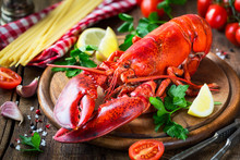 Steamed Red Lobster On A Wooden Cutting Board With Parsley, Lemon Wedges And Spaghetti At The Background. Spaghetti All'astice Or Lobster Spaghetti Recipe