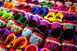 © wanchanta - Rows of colorful hand made baby shoes in market