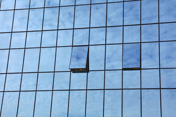 Cloudy sky reflection in business building glass