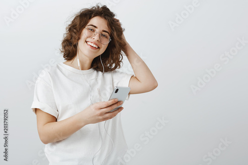 Studio Portrait Of Happy Relaxed Young Woman With Short Curly Hair
