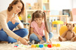 © Africa Studio - Female psychologist with cute little girl during play therapy