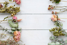 Romantic Dried Flower And Twigs Composition On White Wooden Background. Copyspace Concept