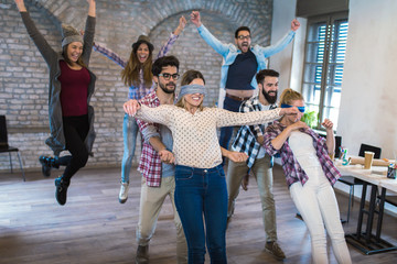 Business people making team training exercise during team building seminar, play a game of trust