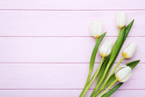 Fototapeta Tulipany - Bouquet of white tulips on pink wooden table