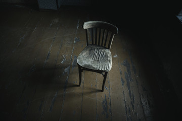 Brown wooden  chairs on a dark background