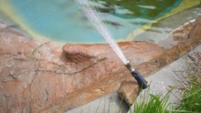 Water Pressure Hose Shooting Misting Water Into Zoo Marine Enclosure
