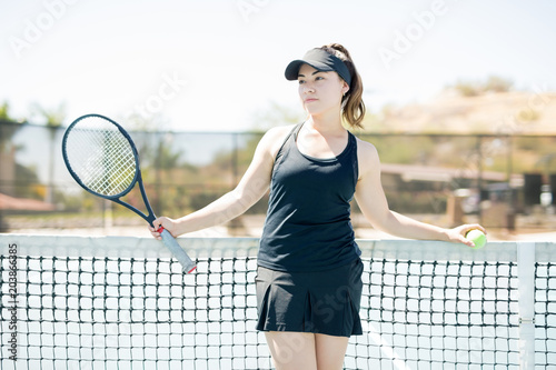 Tennis player taking break after practicing Poster