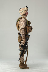 Wall Mural - Soldier in camouflage holding rifle