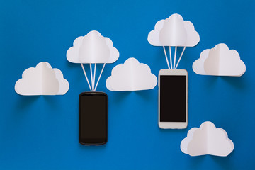 Network connection and cloud storage technology concept. Data communications and cloud computing network concept. Smart phone flying on paper cloud. Origami. Paper cut. Top view