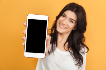Pretty woman showing display of mobile phone.