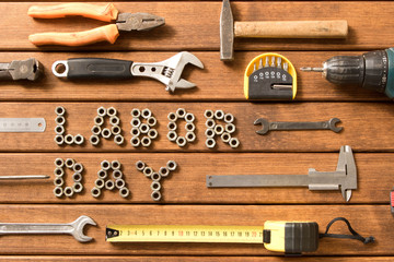 Wall Mural - Labor day. Different tools on wooden background .