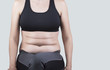© TheFarAwayKingdom - Female belly with excess weight and a woman in sportswear sitting on a chair. Body Positive Style