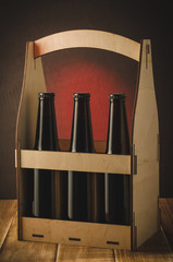 Wall Mural - beer bottles in a wooden case/beer bottles in a wooden case on a dark background