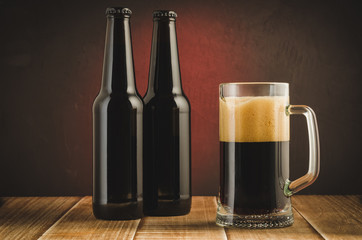 Wall Mural - Beer mug and bottles on wooden shelf/Beer mug and bottles on wooden shelf on a red background