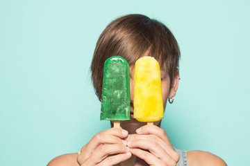 Beautiful girl with ice cream on a blue background