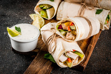 Healthy Lunch Snack. Stack Of Mexican Street Food Fajita Tortilla Wraps With Grilled Buffalo Chicken Fillet And Fresh Vegetables, Dark Background Copy Space